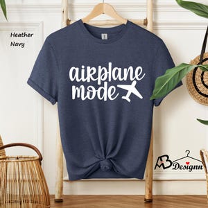 May include: A heather navy blue t-shirt with the text "airplane mode" in white with a white airplane graphic.