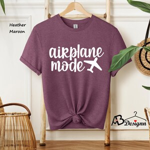 May include: Heather maroon t-shirt with white text that says "airplane mode" and a small airplane graphic.