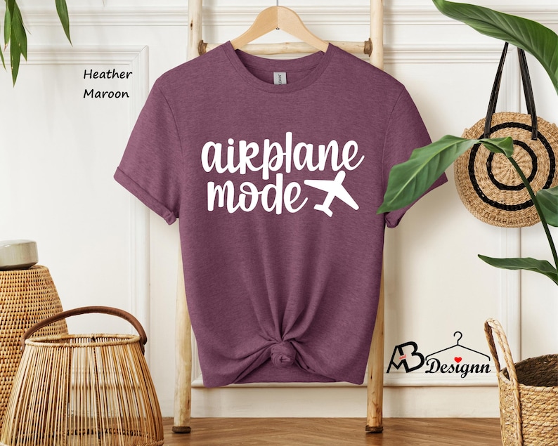 May include: Heather maroon t-shirt with white text that says "airplane mode" and a small airplane graphic.