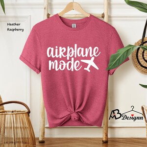May include: Heather raspberry t-shirt with the text "airplane mode" and a white airplane graphic.