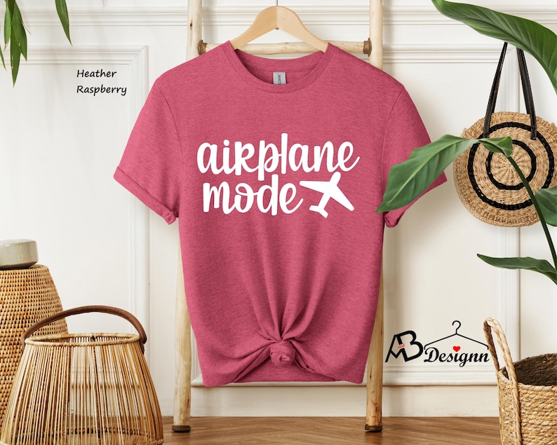 May include: Heather raspberry t-shirt with the text "airplane mode" and a white airplane graphic.
