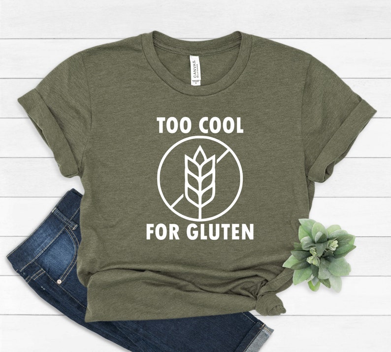 May include: A green t-shirt with the text "Too Cool For Gluten" and a white graphic of a wheat stalk with a diagonal line through it.