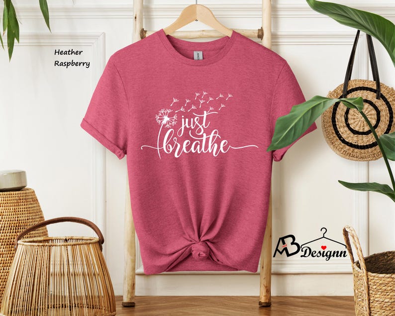 May include: Heather raspberry t-shirt with a white dandelion graphic and the text "just breathe".