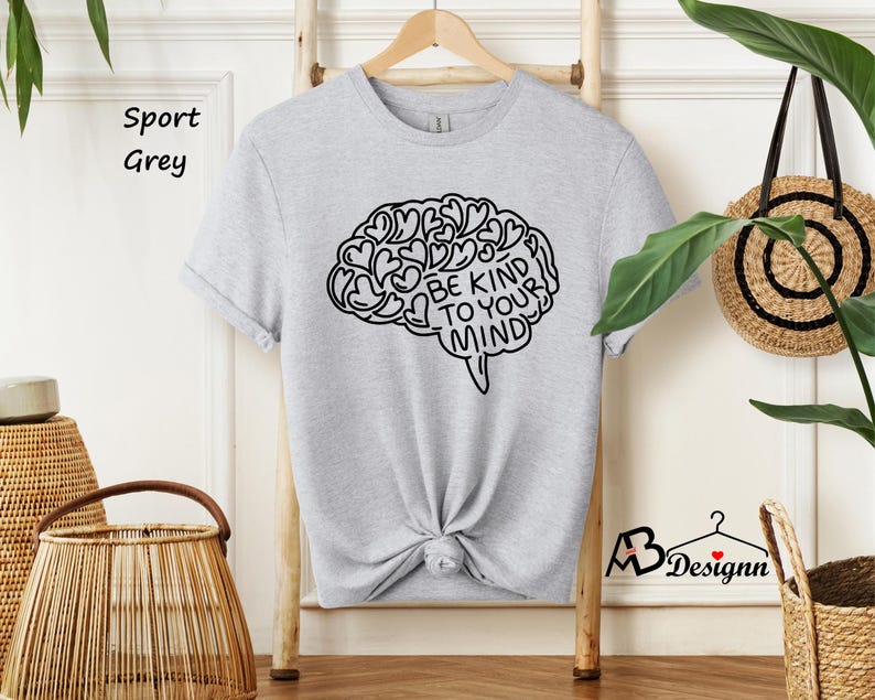 May include: A gray sport t-shirt with a black outline of a brain with hearts inside and the text "Be Kind To Your Mind".