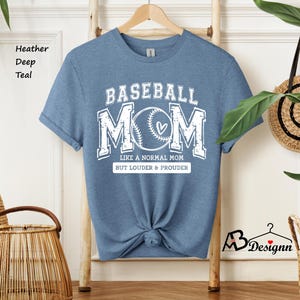 May include: A light blue t-shirt with the text "BASEBALL MOM" in white. The text is surrounded by a baseball graphic and the words "Like a normal mom but louder & prouder".