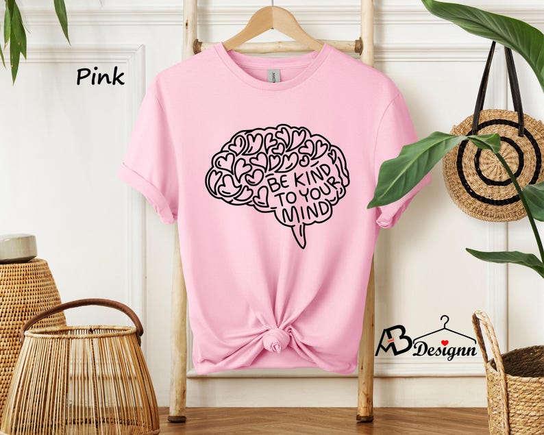 May include: Pink t-shirt with a black graphic of a brain with hearts and the text "Be Kind To Your Mind".