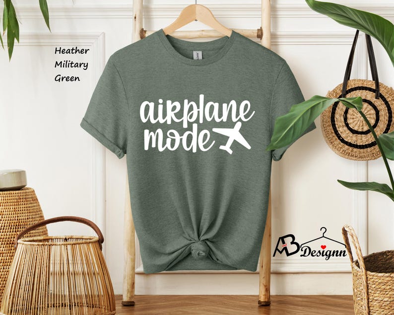 May include: A heather military green t-shirt with the text "airplane mode" in white lettering and a small airplane graphic.