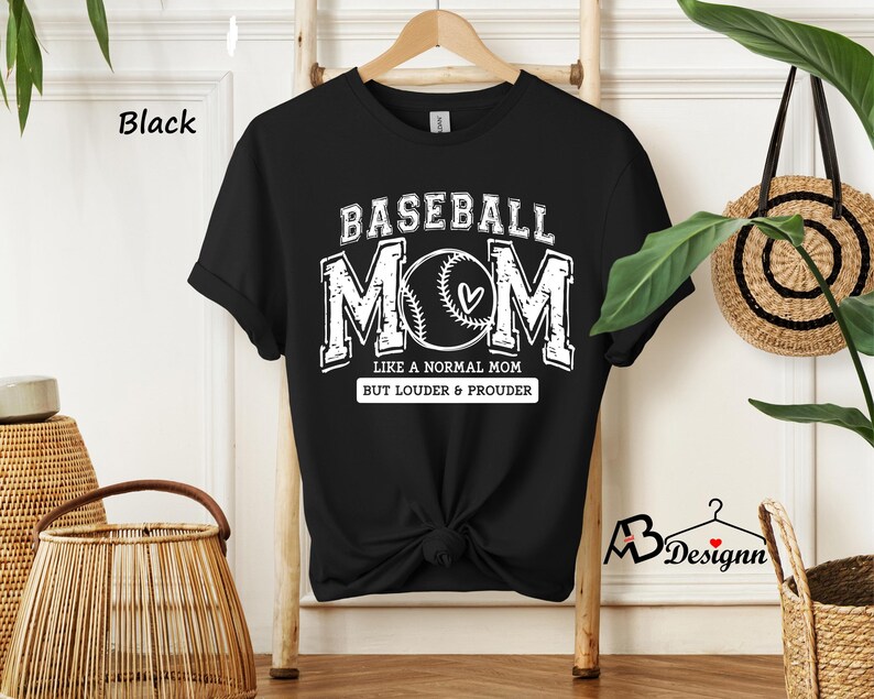 May include: Black t-shirt with a white graphic that says "Baseball Mom" with a baseball and heart design. The text below the graphic says "Like a normal mom but louder & prouder."