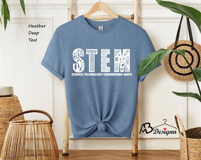 May include: A blue t-shirt with a white graphic that says "STEM" with icons representing science, technology, engineering, and math. The text below the graphic says "SCIENCE TECHNOLOGY ENGINEERING MATH".