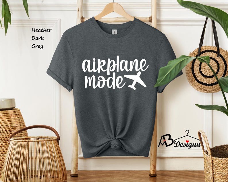 May include: A dark heather grey t-shirt with the text "airplane mode" in white lettering and a small airplane graphic.