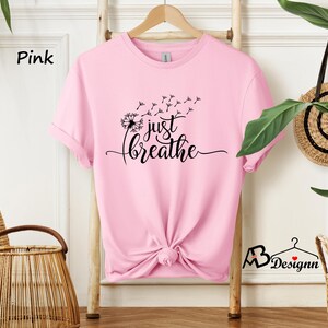 May include: Pink t-shirt with a dandelion graphic and the text "just breathe".