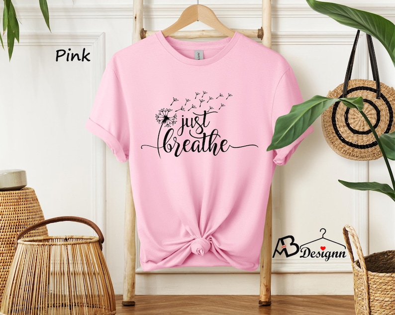 May include: Pink t-shirt with a dandelion graphic and the text "just breathe".