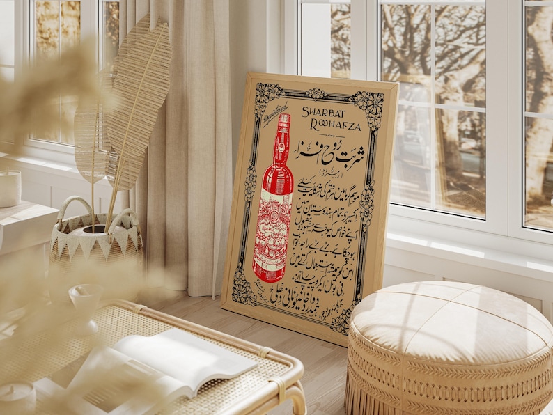 May include: Vintage advertisement poster for Sharbat Rooh Afza, a red beverage. The poster features a bottle of the drink and Urdu text.