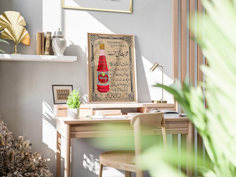 May include: Vintage poster advertising Sharbat Rahafza, a red beverage in a glass bottle. The poster features Urdu text and a decorative border.