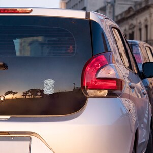 A premium 3 inch by 2 inch die-cut vinyl sticker. The sticker graphic is a black and white cluster of mushrooms with black text. The text says That's What I Do. I Grow Mushrooms And Know Things. Our stickers are waterproof/UV resistant.