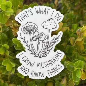 A premium 3 inch by 2 inch die-cut vinyl sticker. The sticker graphic is a black and white cluster of mushrooms with black text. The text says That's What I Do. I Grow Mushrooms And Know Things. Our stickers are waterproof/UV resistant.