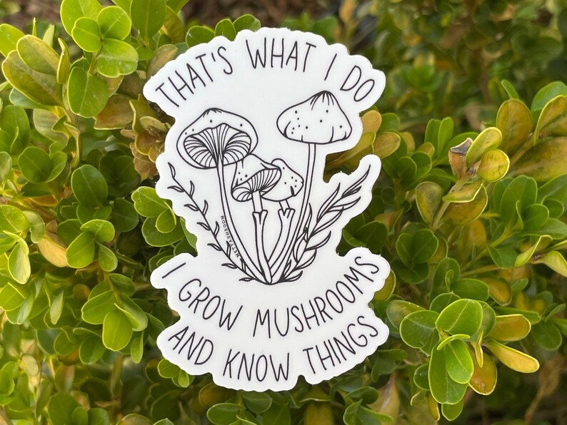 A premium 3 inch by 2 inch die-cut vinyl sticker. The sticker graphic is a black and white cluster of mushrooms with black text. The text says That's What I Do. I Grow Mushrooms And Know Things. Our stickers are waterproof/UV resistant.