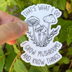 A premium 3 inch by 2 inch die-cut vinyl sticker. The sticker graphic is a black and white cluster of mushrooms with black text. The text says That's What I Do. I Grow Mushrooms And Know Things. Our stickers are waterproof/UV resistant.