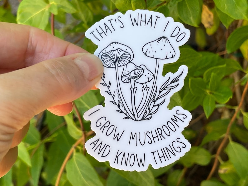 A premium 3 inch by 2 inch die-cut vinyl sticker. The sticker graphic is a black and white cluster of mushrooms with black text. The text says That's What I Do. I Grow Mushrooms And Know Things. Our stickers are waterproof/UV resistant.