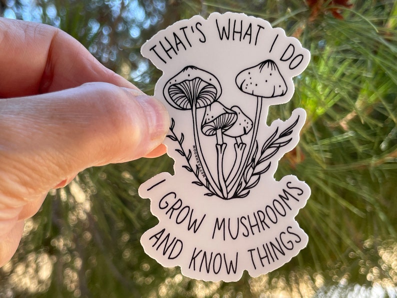 A premium 3 inch by 2 inch die-cut vinyl sticker. The sticker graphic is a black and white cluster of mushrooms with black text. The text says That's What I Do. I Grow Mushrooms And Know Things. Our stickers are waterproof/UV resistant.