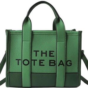 May include: A green tote bag with black straps and the text "THE TOTE BAG" printed on the front.