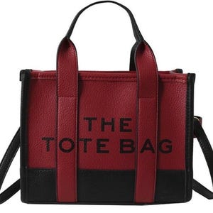 May include: A red and black tote bag with the text "THE TOTE BAG" printed on the front.