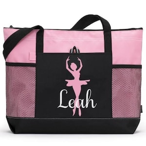 May include: Pink and black tote bag with a mesh pocket on each side. The front of the bag features a silhouette of a ballerina with the name "Leah" written below.