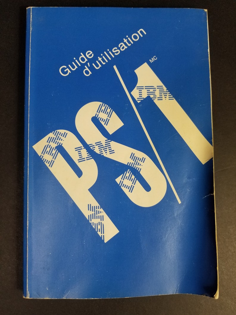 Puede incluir: Una gu&iacute;a azul con el texto "Guide d'utilisation" y el logotipo de IBM en blanco.