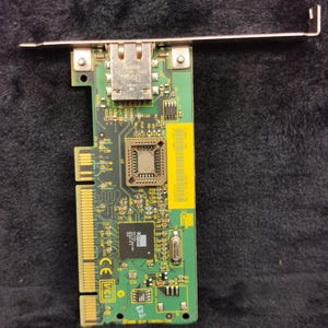 May include: A green circuit board with a network card, a chip, and a RJ-45 connector. The board has text that says "3Com Corporation".