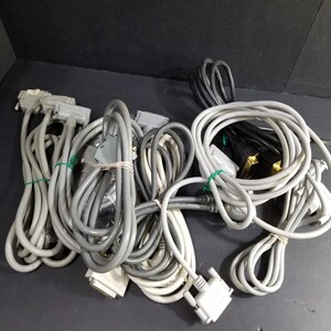 May include: A pile of grey and black computer cables with various connectors, including VGA, DVI, and DB-9.