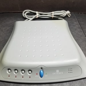 May include: A gray Inter-ex phone system with four buttons and a blue button with a microphone icon. The system has a power indicator light and a green light labeled "online".