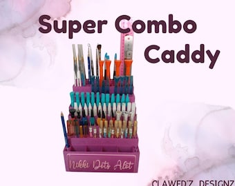 May include: A purple Super Combo Caddy filled with various art tools, including paintbrushes, pens, and other supplies. The caddy has multiple compartments and a ruler. The text "Nikki Dots Alot" is visible on the front.