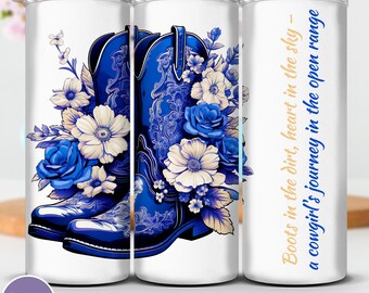 May include: A white tumbler with a design of blue cowboy boots and blue and white floral accents. The tumbler has the text "Boots in the dirt, heart in the sky - a cowgirl's journey in the open range."