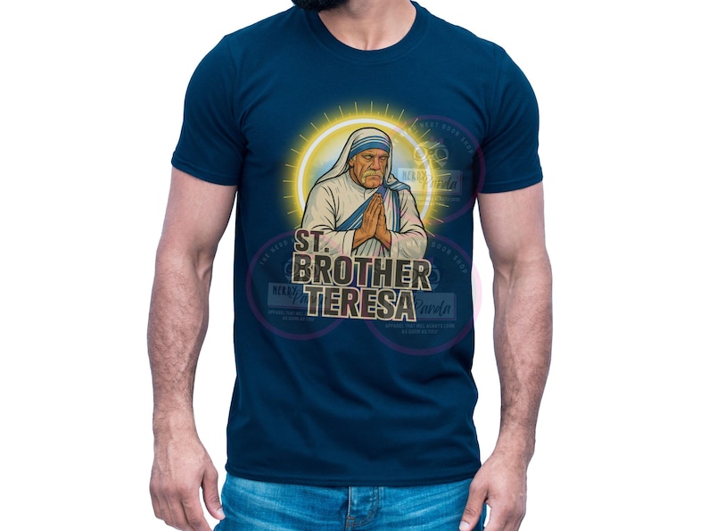 May include: Navy blue t-shirt featuring an illustration of St. Brother Teresa with a yellow halo. The graphic includes the text "ST. BROTHER TERESA" in a stylized font. The shirt is a classic crew neck style.