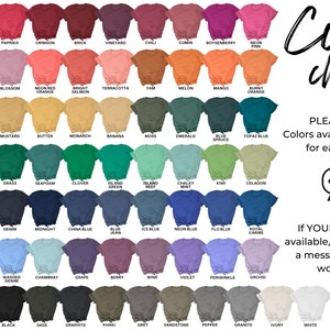 May include: Color chart showing 64 different colors of t-shirts. The colors are arranged in rows and columns, with the names of each color listed below the corresponding t-shirt. The text "Color chart" is written in a large, stylized font at the top right of the image. The text "PLEASE NOTE: Colors available may vary for each design." is written in black text below the color chart. A speech bubble with three dots is below the text. The text "If YOUR color is not available, please send us a message and we'll work it out!" is written in black text below the speech bubble.