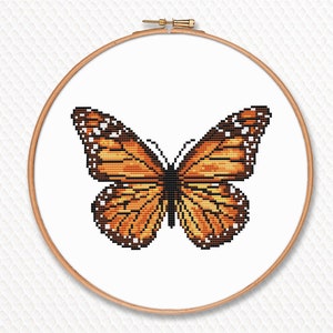 May include: A cross-stitch pattern of a monarch butterfly with orange, black, and white wings.