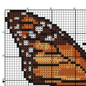 May include: Cross stitch pattern of a butterfly with brown, orange, and white wings. The pattern is on a grid with numbers for reference.