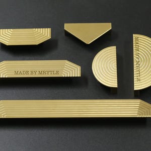 Proste gałki, uchwyty do szafek w kształcie półksiężyca, uchwyty do szuflad komód, grawerowane uchwyty do drzwi, uchwyty do szaf, gałki do mebli