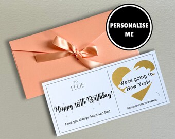 May include: A pink envelope with a satin ribbon tied around it. The envelope is open to reveal a white card with the text "Happy 18th Birthday!" and a gold heart with the text "We're going to New York!" that can be scratched to reveal a surprise.