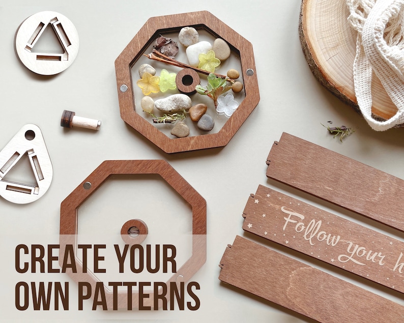 May include: Wooden octagon-shaped frame with a clear window, filled with natural elements like stones, leaves, and twigs.  Two smaller wooden frames with a triangular cutout are also shown. The text "CREATE YOUR OWN PATTERNS" is printed below the octagon frame.