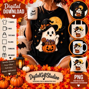 May include: A black t-shirt featuring a white ghost wearing a witch hat and holding a pumpkin filled with candy, set against a yellow moon background. The design includes bats and stars. The image also displays a white mug with the text Boo.