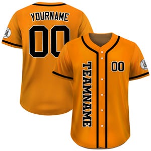 Pode incluir: Camisola de beisebol laranja com acabamentos e detalhes em preto. A camisola apresenta a palavra "YOURNAME" e o n&uacute;mero "00" nas costas. A frente tem a palavra "TEAMNAME" na vertical e o n&uacute;mero "00".