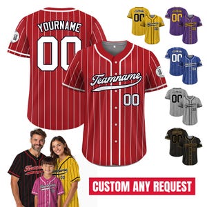 May include: A red and white striped baseball jersey with a white number "00" and the text "YOURNAME" on the front. The jersey also has the text "Teamname" in a cursive font on the front. The jersey is shown on a white background with other jerseys in different colors.