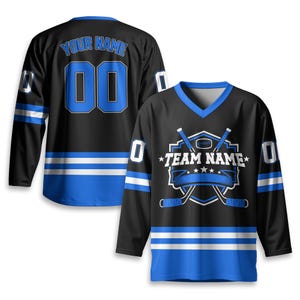 May include: Black hockey jersey with blue accents, featuring the text "YOUR NAME" and the number "00" on the back. The front displays a hockey-themed logo with the text "TEAM NAME". The jersey has a V-neck and long sleeves.
