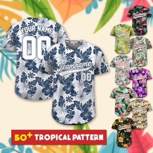 May include: A white and navy blue baseball jersey featuring a tropical hibiscus and leaf pattern. The front displays the text Teamname and the number 00, while the back shows the text Your Name and the number 00. Multiple color variations are shown.