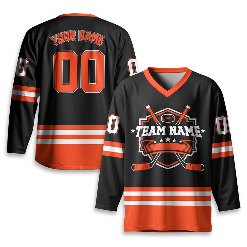 May include: Black hockey jersey with orange and white accents. The jersey features the text "YOUR NAME" above the number "00" on the back. The front displays a hockey-themed logo with the text "TEAM NAME".