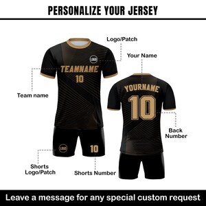 May include: Black and gold soccer jersey with a geometric pattern. The jersey has a team name, player name, and number. It also has a logo on the front and back. The jersey is shown with matching shorts.