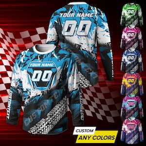 May include: A long-sleeved jersey with a blue, white, and black design. The jersey features the text "YOUR NAME" and the number "00" on the front and back. The words "CUSTOM TEXT" are printed on the sleeves. The bottom of the image says "CUSTOM ANY COLORS".