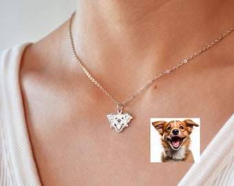 May include: A silver necklace with a pendant featuring a dog's face. The pendant is a close-up of the dog's face, with the dog's tongue sticking out. The necklace is on a model wearing a white shirt.