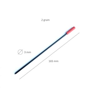 May include: A thin, straight black rod with a small red cylindrical cap at one end. The rod has a diameter of 3 mm, a length of 165 mm, and a weight of 2 gram, as indicated by the text and lines visible in the image.